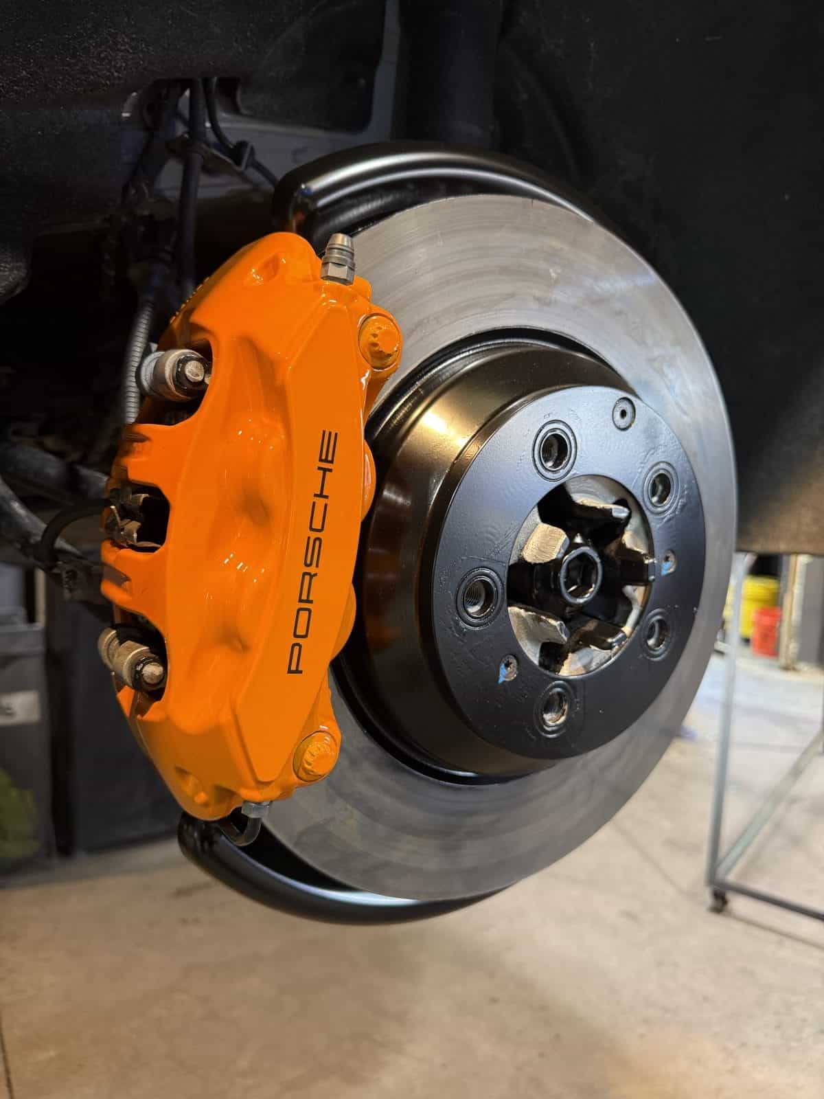 Porsche caliper after orange powder coating rear view