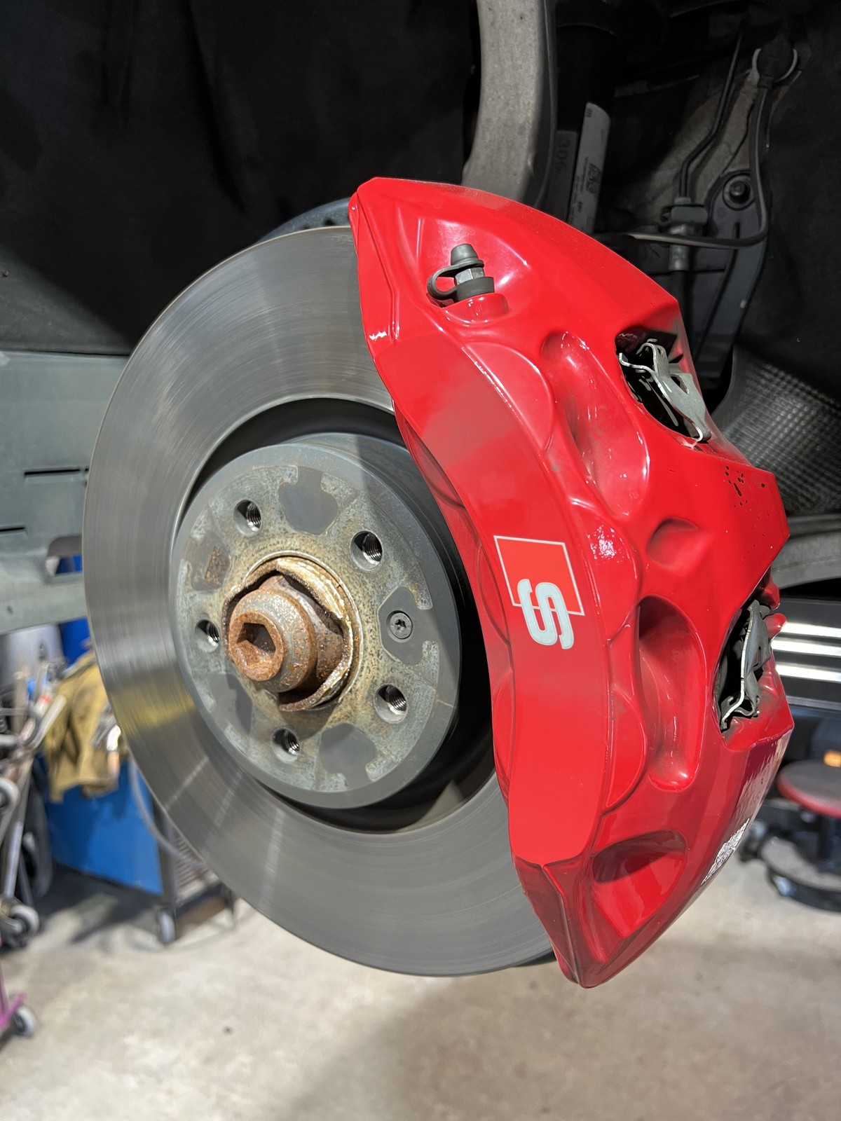 Audi caliper before powder coating red rusty hub