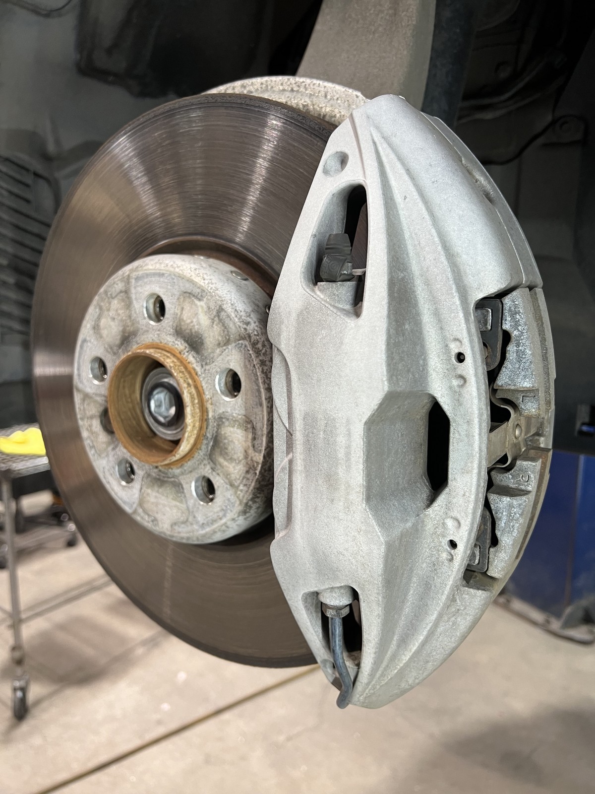 BMW caliper before powder coating raw silver