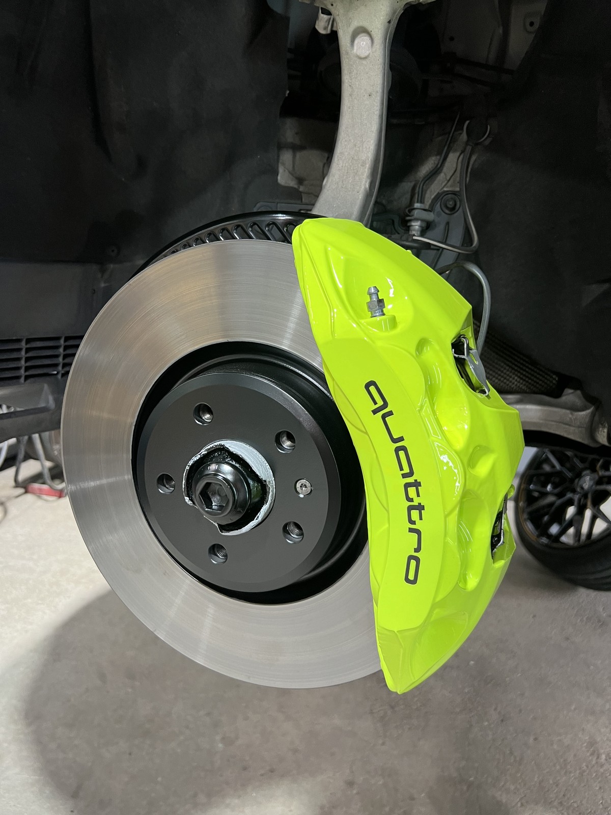 Audi Quattro caliper after neon green powder coating