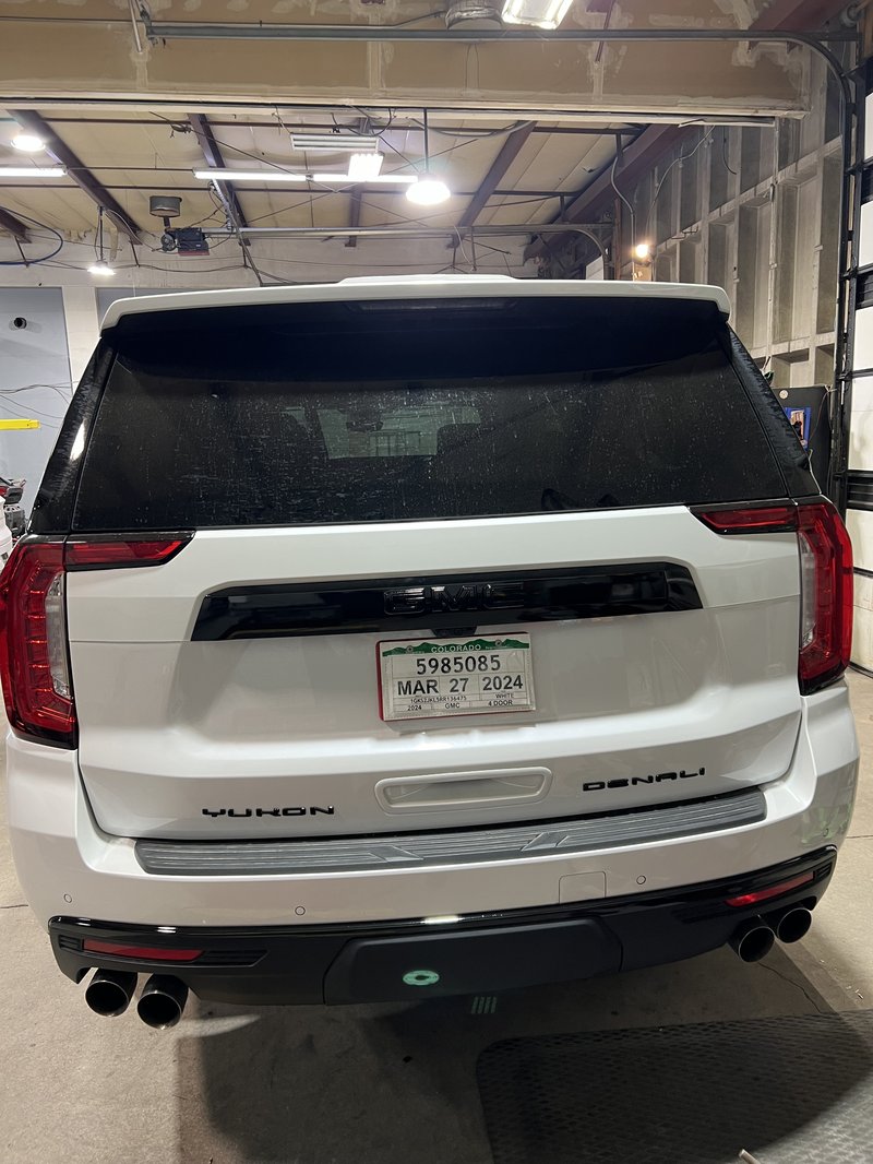 AFTER: White Yukon Denali chrome delete rear badges blacked out Denver