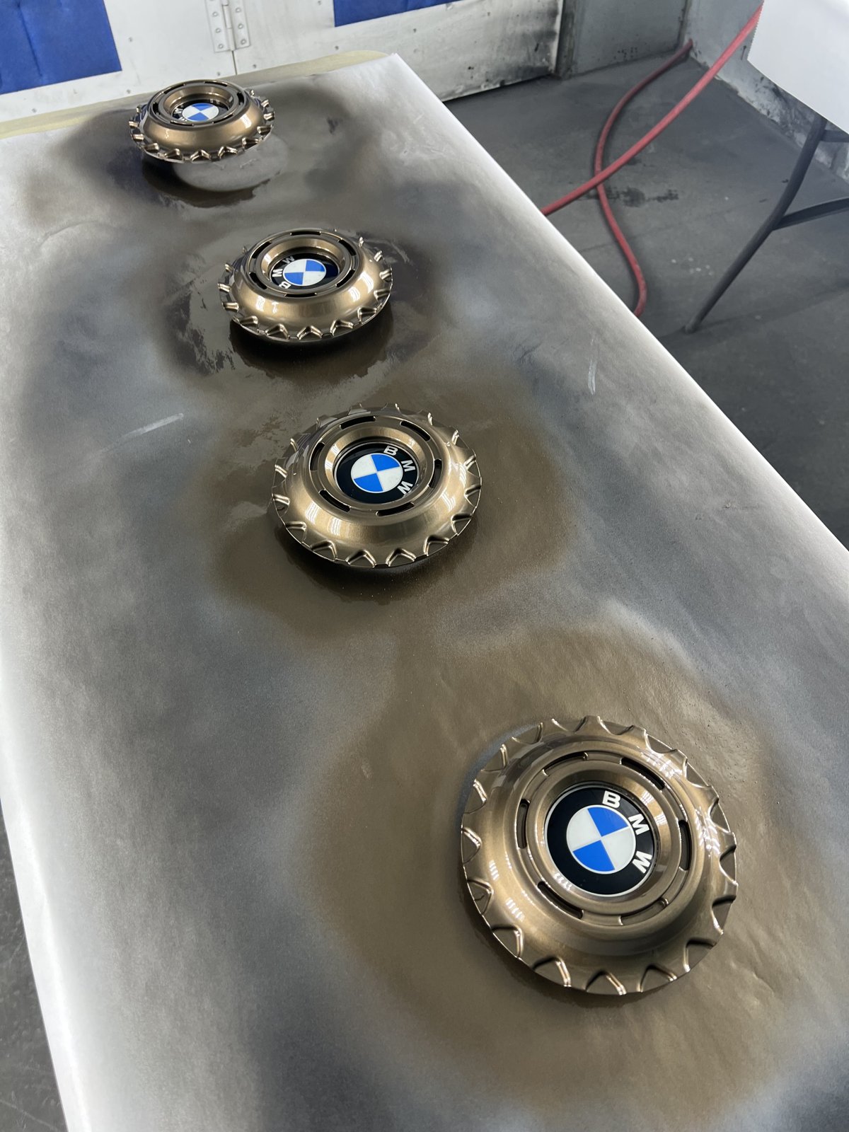 BMW center caps being prepped for painting Denver