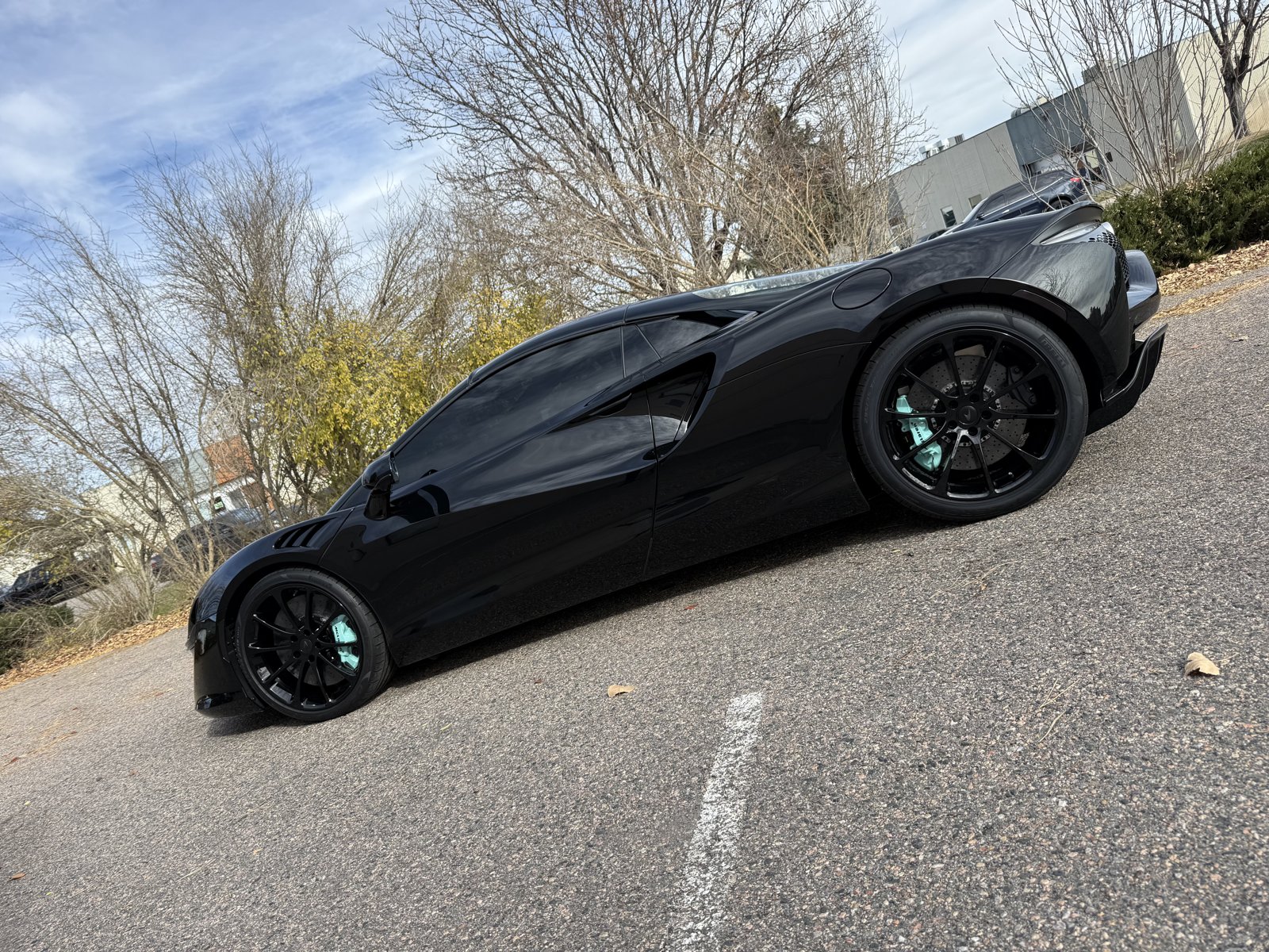 Black C8 Corvette with teal powder coated wheels
