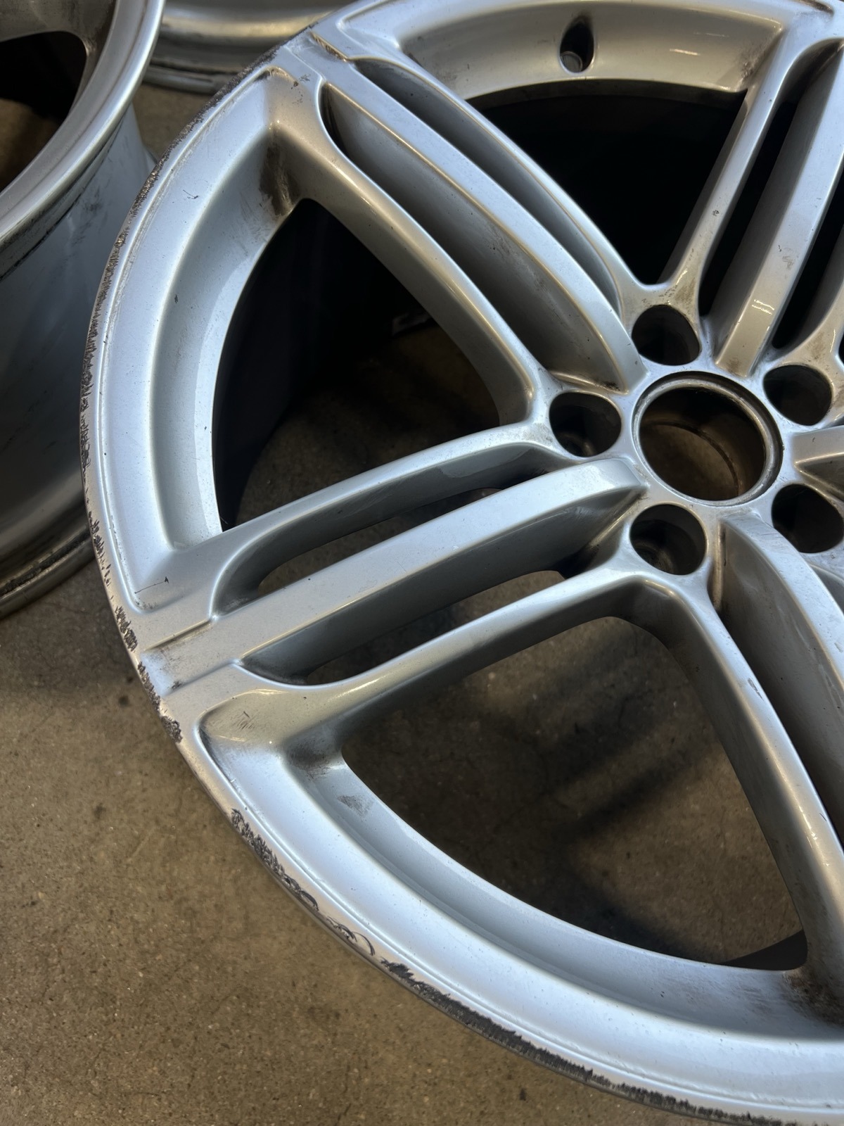 BMW wheel with curb rash before repair Denver